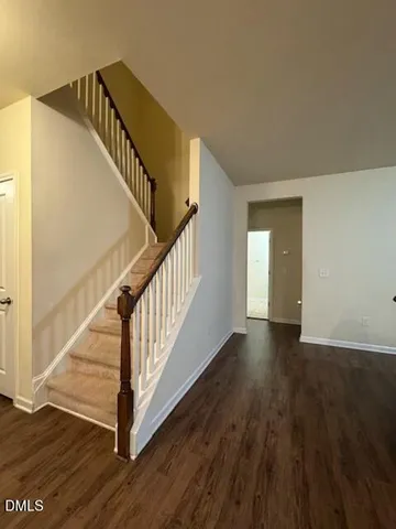 a view of a workspace with furniture and wooden floor