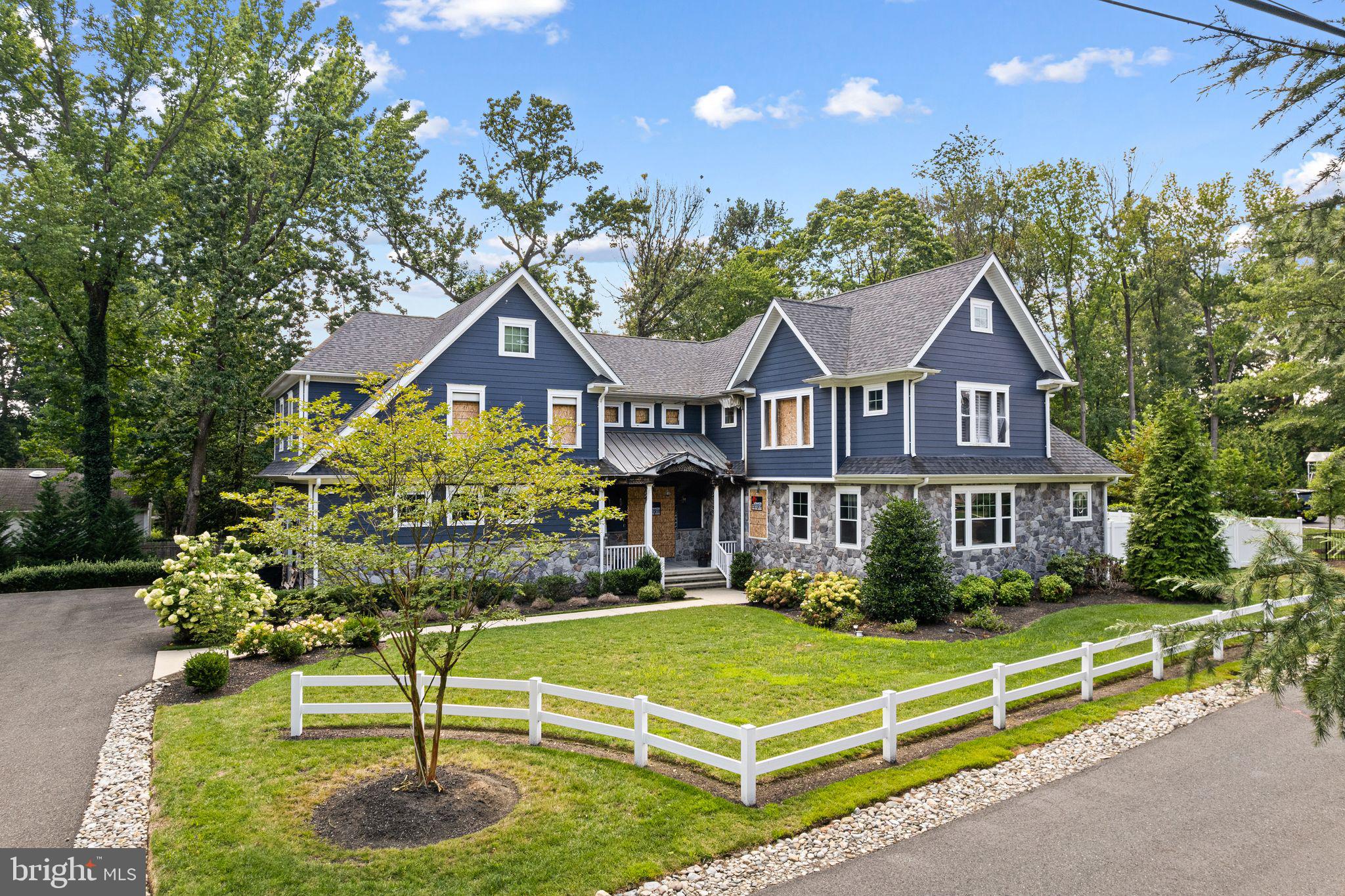 582 Jobel Drive Haddonfield, NJ 08033 - Photo 3 of 9 a front view of a house with a yard table and chairs
