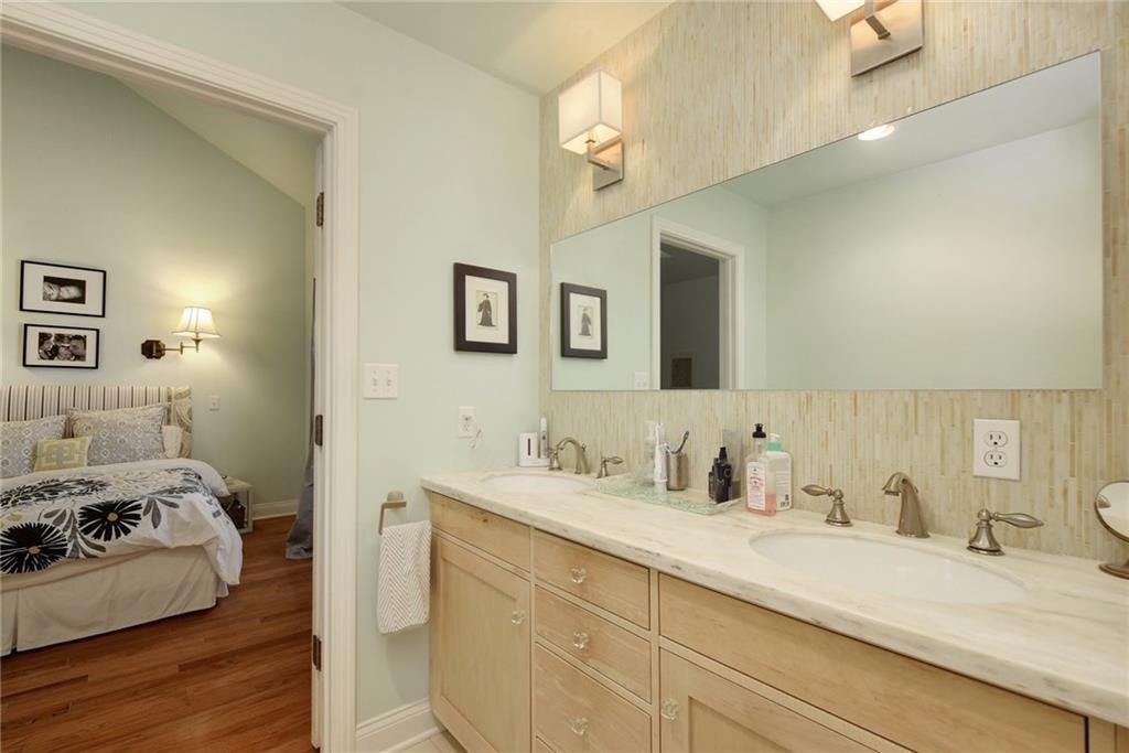 4412 Barrow Avenue, Unit A Austin, TX 78751 - Photo 18 of 28 Full bathroom featuring double vanity, ensuite bath, light wood-type flooring, and backsplash