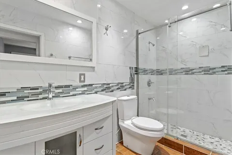 a bathroom with a sink toilet and shower