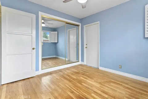 an empty room with a bathroom and a mirror