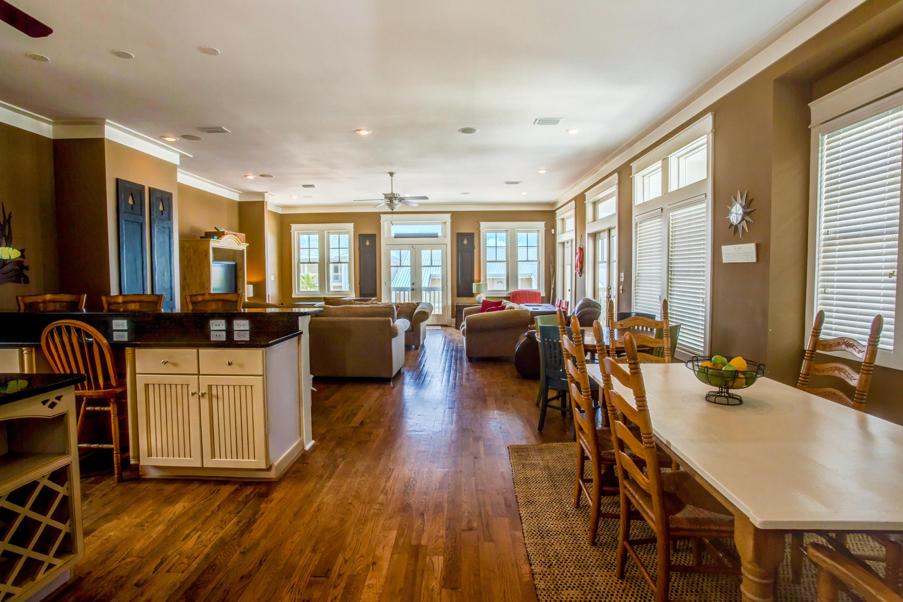 80 Chelsea Loop Road Santa Rosa Beach, FL 32459 - Photo 11 of 43 a large living room with kitchen island granite countertop wooden floors and wide stainless steel appliances