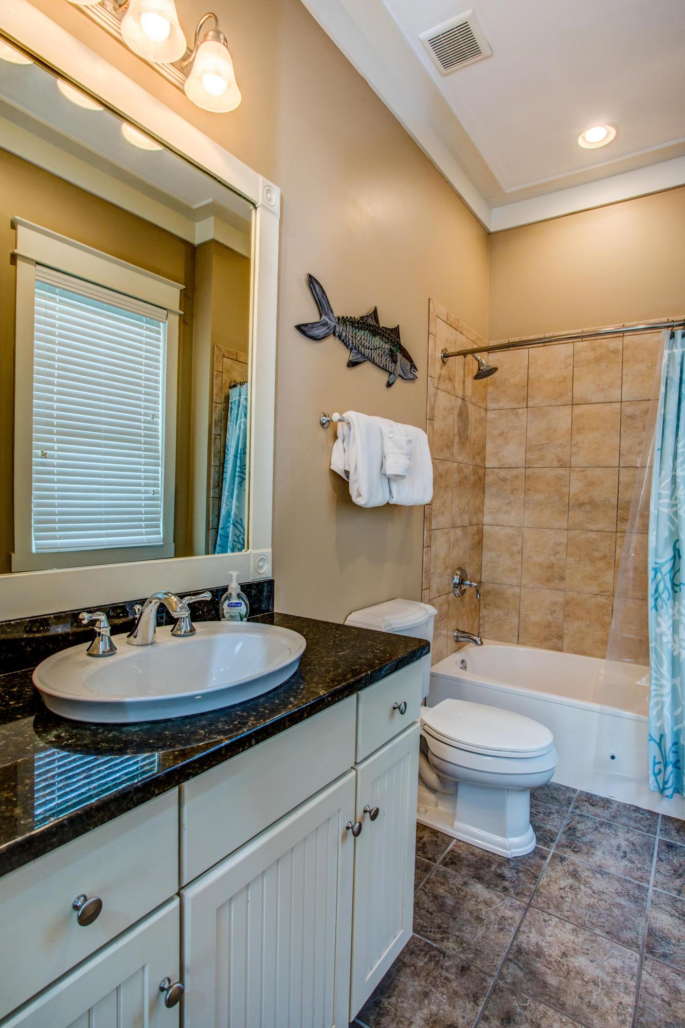 80 Chelsea Loop Road Santa Rosa Beach, FL 32459 - Photo 23 of 43 a bathroom with a double vanity sink toilet and a mirror