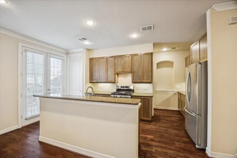 a kitchen with stainless steel appliances granite countertop a sink and cabinets