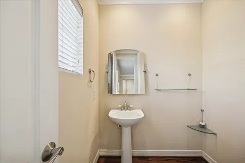 a bathroom with a sink a mirror and a window