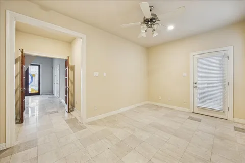 a view of a hallway with a chandelier fan