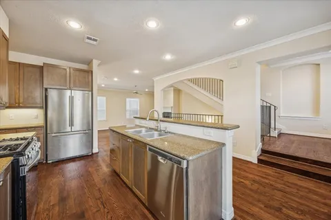 a kitchen with a stove a refrigerator and a sink