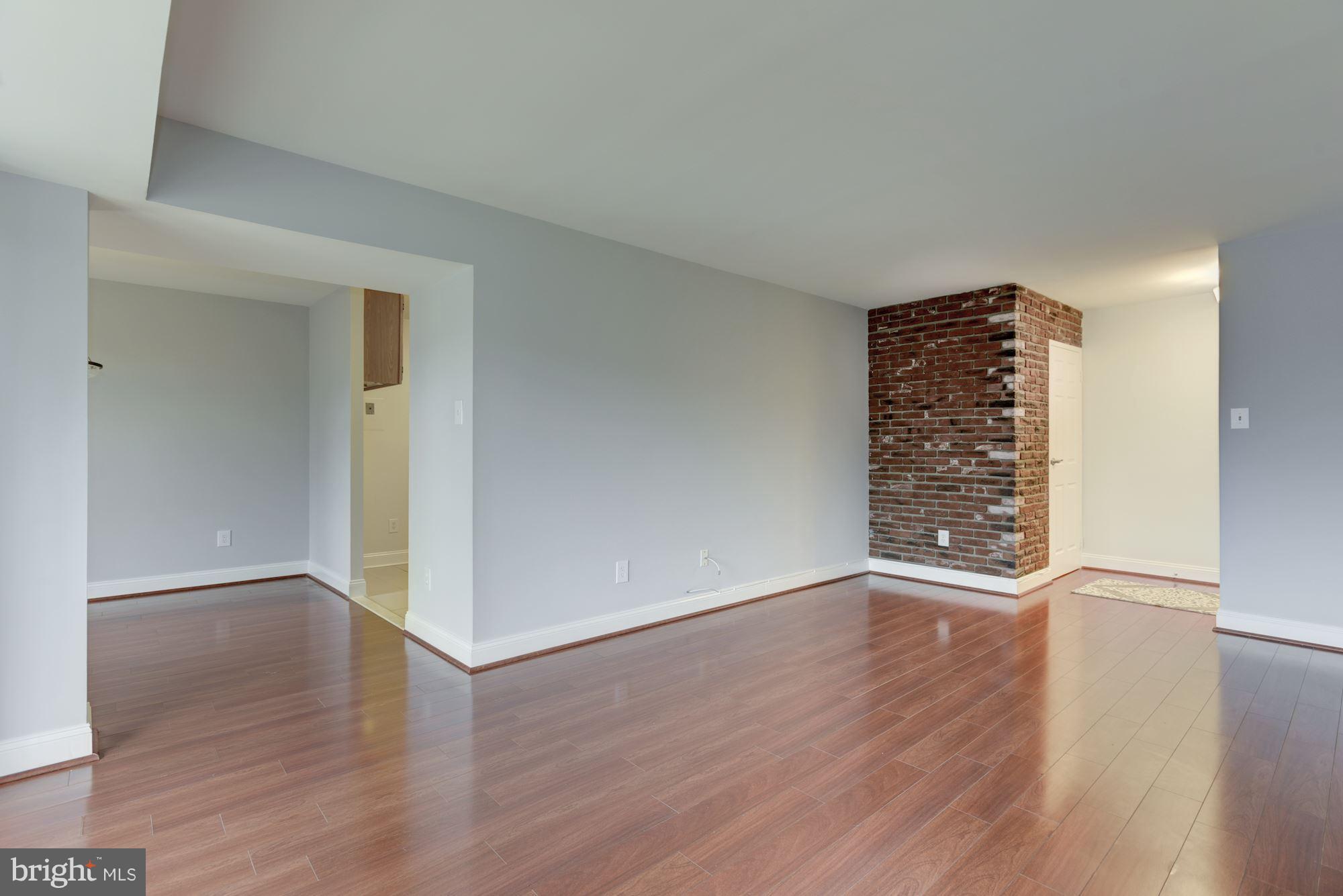 2018 Colts Neck Road, Unit 22 Reston, VA 20191 - Photo 1 of 26 Living Room with beautiful flooring, and brick.