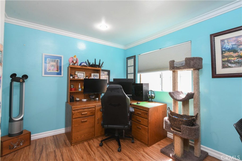 4616 North Roxburgh Avenue Covina, CA 91722 - Photo 11 of 23 a view of a workspace with furniture and wooden floor