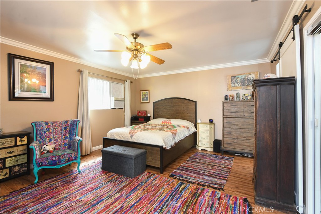 4616 North Roxburgh Avenue Covina, CA 91722 - Photo 12 of 23 a bedroom with a bed and wooden floor