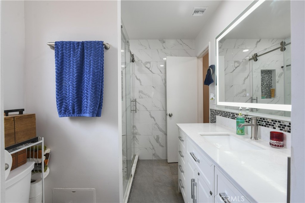 4616 North Roxburgh Avenue Covina, CA 91722 - Photo 15 of 23 a bathroom with a double vanity sink mirror and shower