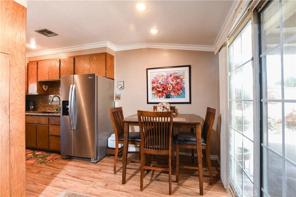 4616 North Roxburgh Avenue Covina, CA 91722 - Photo 5 of 23 a dining room with furniture a floor to ceiling window and kitchen view