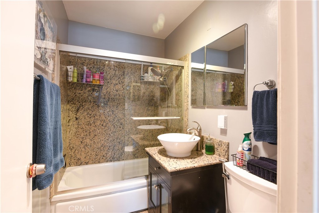 4616 North Roxburgh Avenue Covina, CA 91722 - Photo 9 of 23 a bathroom with a granite countertop sink a toilet and shower