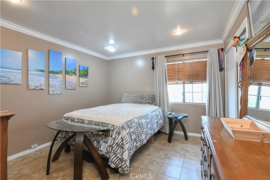 4616 North Roxburgh Avenue Covina, CA 91722 - Photo 10 of 23 a bed room with a bed and a table