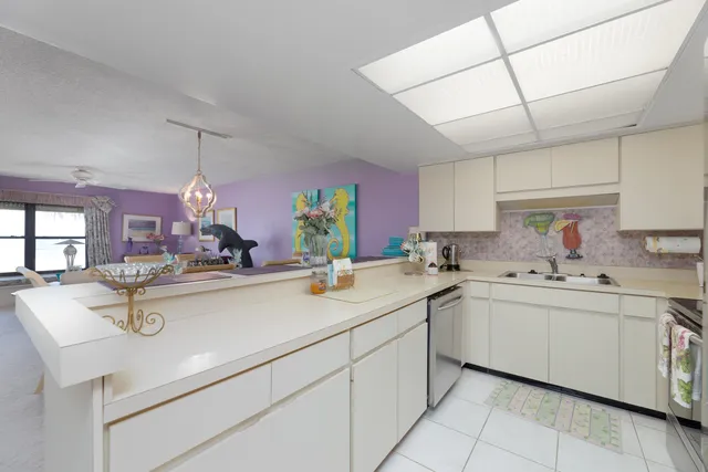 a kitchen with stainless steel appliances granite countertop a sink and a refrigerator