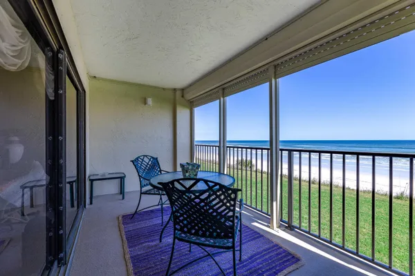 a view of a chairs and table in the balcony