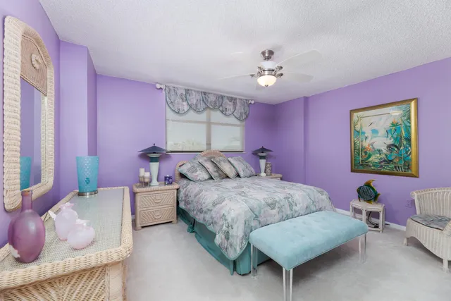 a spacious bedroom with a bed and a chandelier