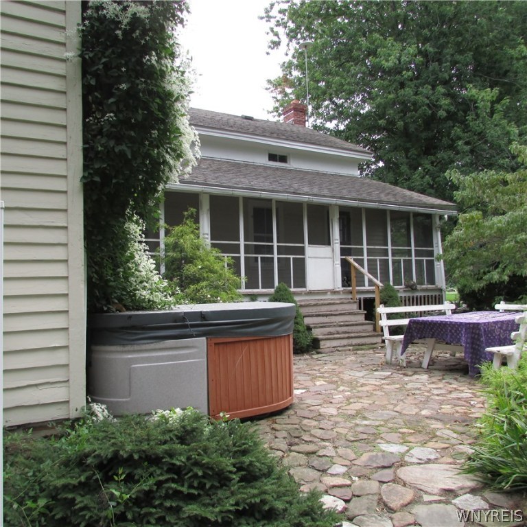 3282 Coomer Road Newfane, NY 14108 - Photo 19 of 25 Large screened in porch with stone patio and hot t