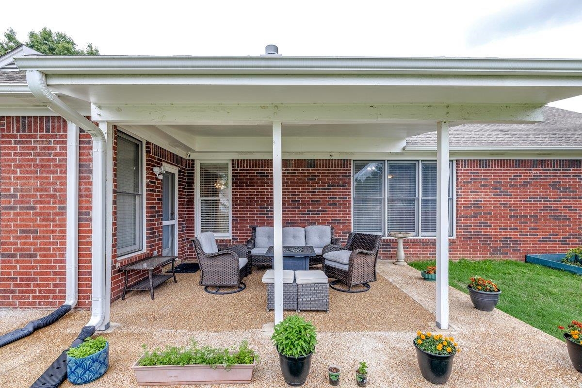 4840 Rainy Pass Road Collierville, TN 38017 - Photo 26 of 30 Covered patio featuring a textured concrete surface and white support columns