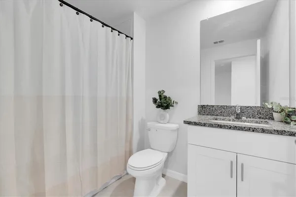 a bathroom with a sink mirror and vanity