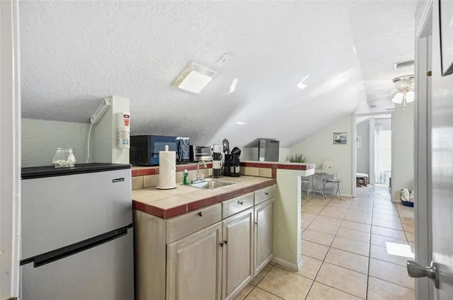 a kitchen with a sink and refrigerator