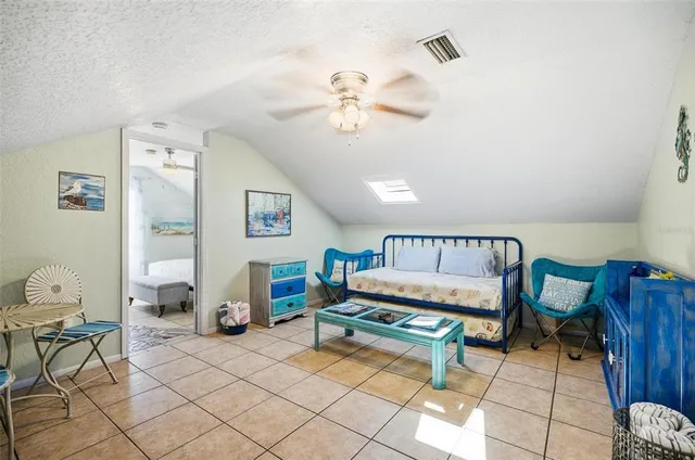 a bedroom with furniture and a chandelier