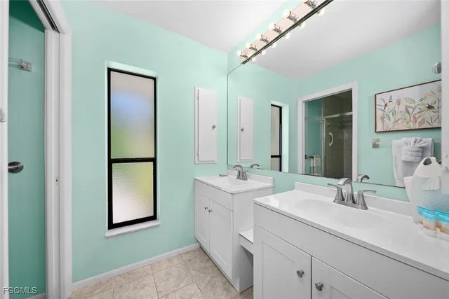 a bathroom with a double vanity sink mirror and toilet