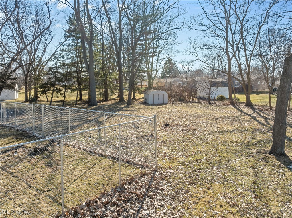 557 Hilliard Road Elyria, OH 44035 - Photo 34 of 38 Full yard extends to the tree line with shed