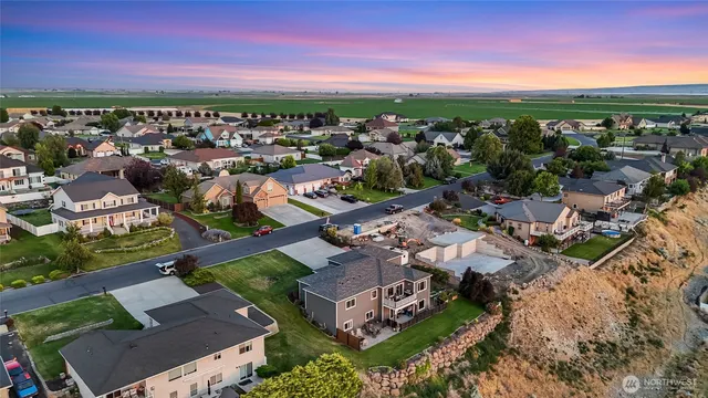 an aerial view of a city with lots of residential buildings and ocean view