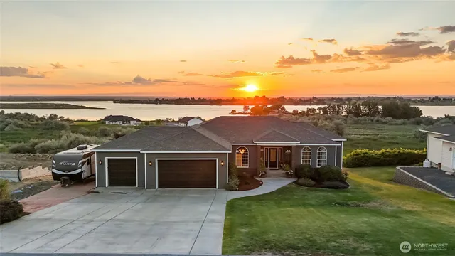 a view of a house with yard and a garden