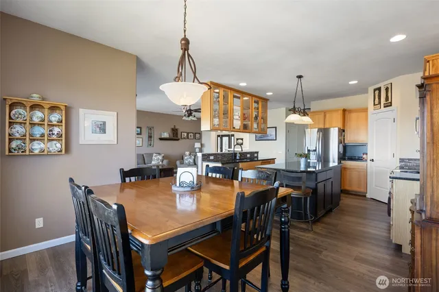 a dining room with furniture window and wooden floor