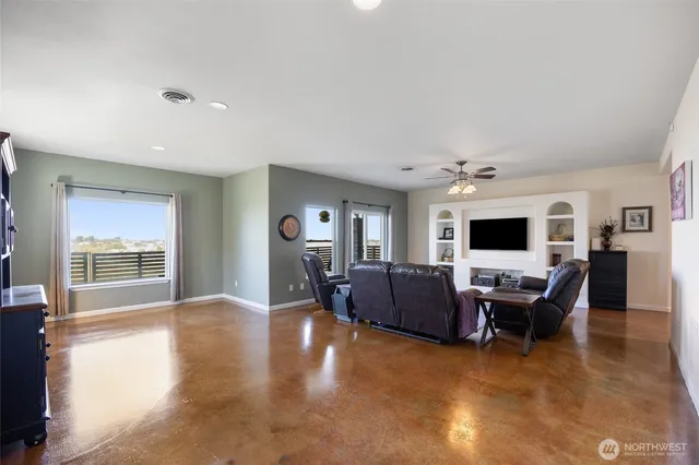a living room with furniture window and a flat screen tv