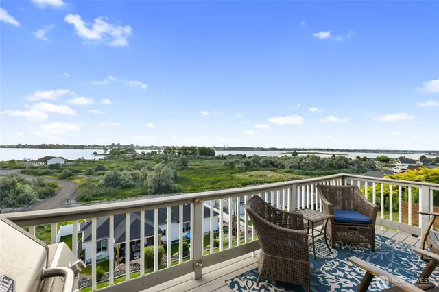 a view of a balcony with wooden floor and fence