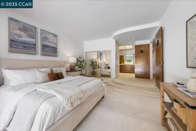 a spacious bathroom with a double vanity sink a mirror and a shower