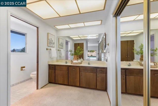 a bathroom with a granite countertop sink mirror and double