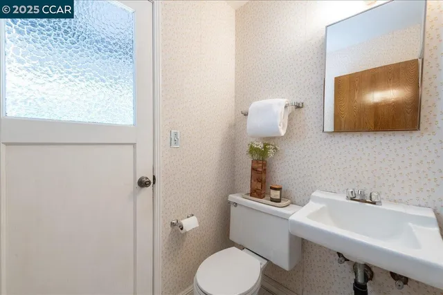 a bedroom with a bed lamp and a window