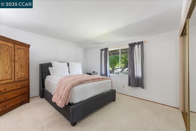 a bedroom with a large bed and a large window