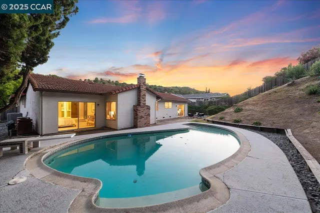 a view of swimming pool with outdoor seating and plants