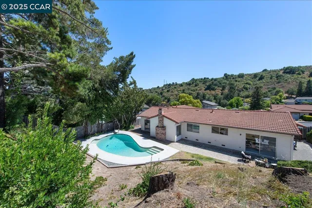 an aerial view of a house with garden space and street view