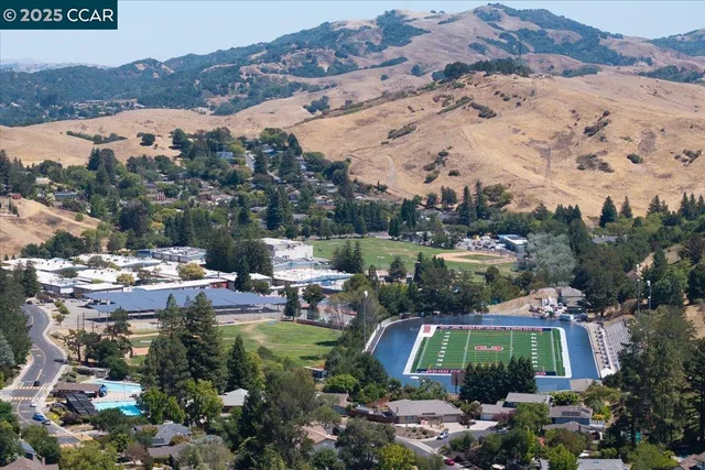 an aerial view of a residential houses and city street