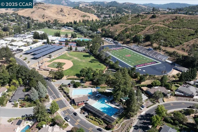 an aerial view of a house with garden space and street view