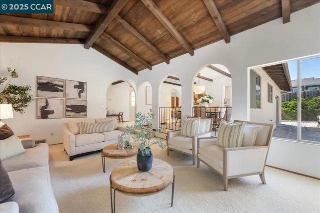 a view of a dining room with furniture and a potted plant