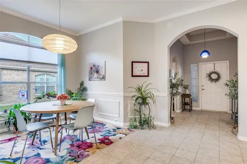 a view of a dining room with furniture and a chandelier