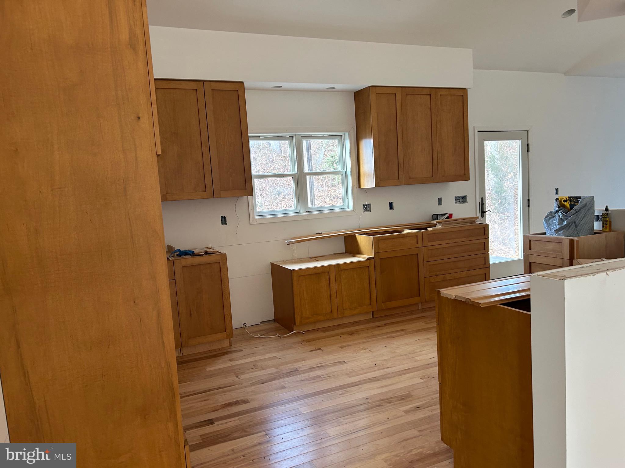 342 South Poes Road Amissville, VA 20106 - Photo 6 of 16 a large kitchen with stainless steel appliances granite countertop a sink stove and wooden floor