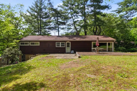 a view of a patio with table and chairs under an umbrella