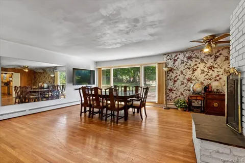 a view of a dining room with furniture window and wooden floor
