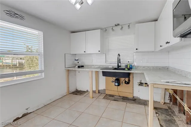 a kitchen with a sink cabinets and window