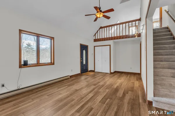 a view of an entryway with wooden floor