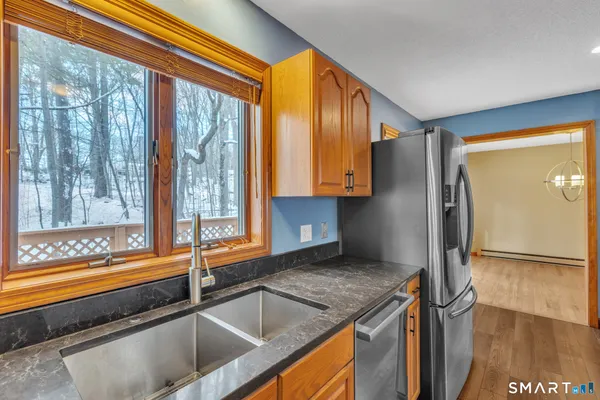 a kitchen with a sink and a large window