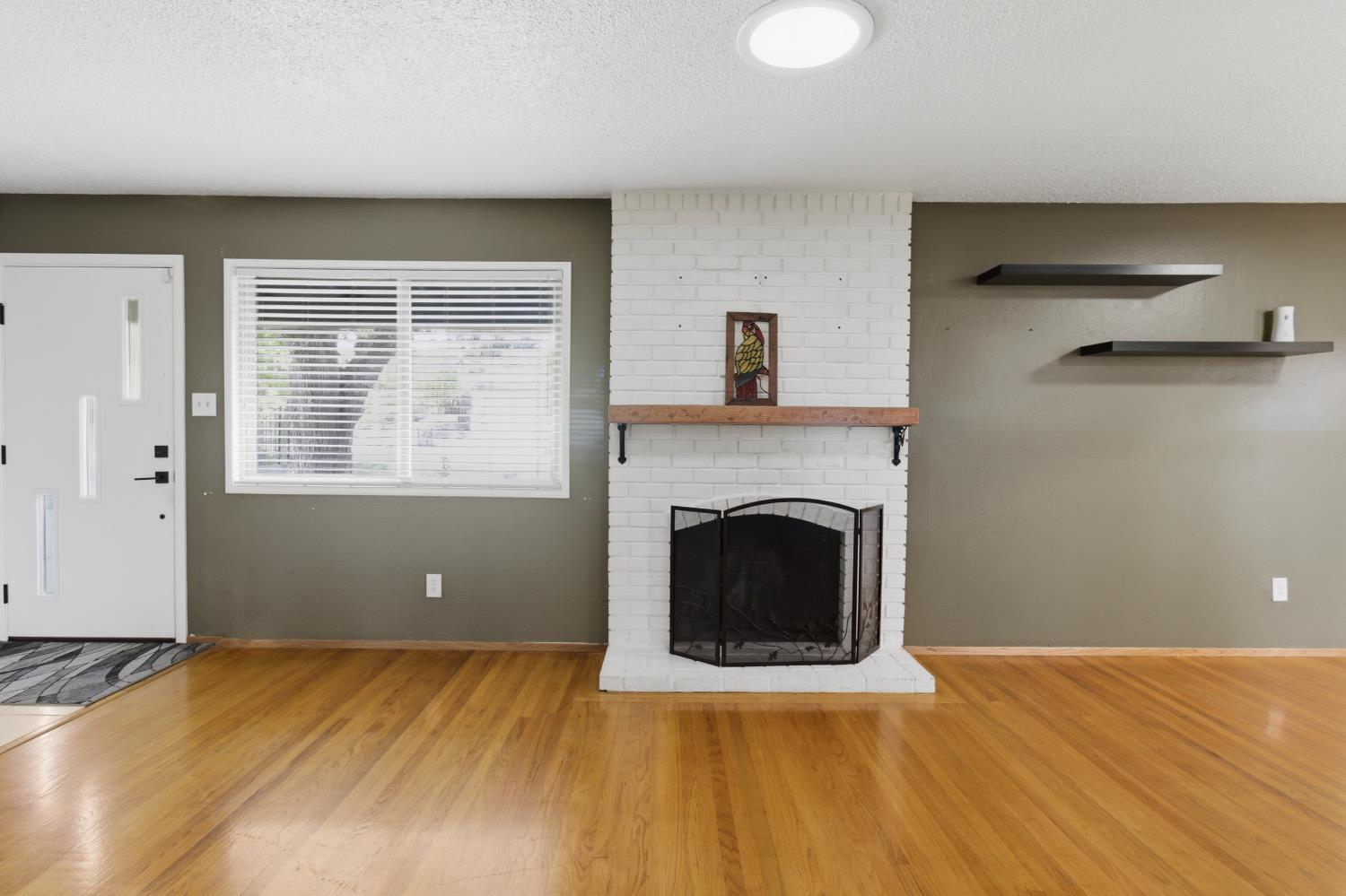 5262 Flagstone Street Carmichael, CA 95608 - Photo 6 of 31 a view of a livingroom with a fireplace wooden floor and windows